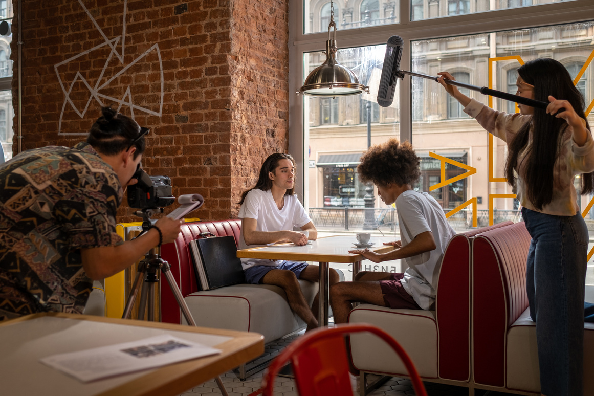 Group of young actors sitting in cafe
